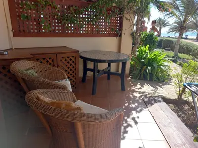 a patio with a table and chairs and a table at Appartamento t0 n 7 situato complesso turistico porto antico 2 in Santa Maria
