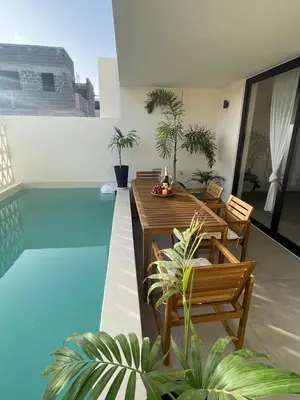 a balcony with a table and chairs and a pool at Lagoon Apartment mit Pool Boa Vista in Sal Rei