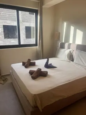 a bedroom with a bed with two towels on it at Lagoon Apartment mit Pool Boa Vista in Sal Rei