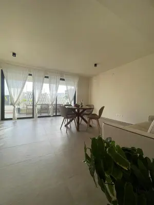 a living room with a table and chairs and a couch at Lagoon Apartment mit Pool Boa Vista in Sal Rei