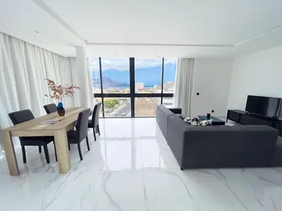 a living room with a table and a couch at Bliss Apartments T2 - Julia in Mindelo