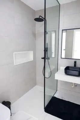 a bathroom with a glass shower and a sink at Bliss Apartments T2 - Julia in Mindelo
