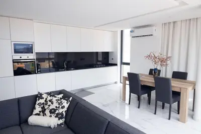 a living room with a couch and a table with chairs at Bliss Apartments T2 - Julia in Mindelo