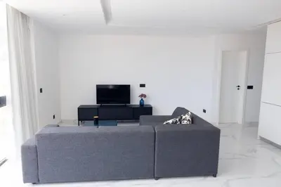 a living room with a couch and a tv at Bliss Apartments T2 - Julia in Mindelo