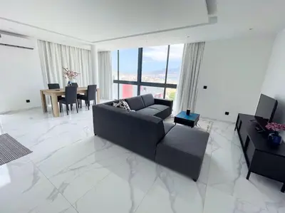 a living room with a black couch and a table at Bliss Apartments T2 - Julia in Mindelo