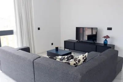 a living room with a couch and a flat screen tv at Bliss Apartments T2 - Julia in Mindelo
