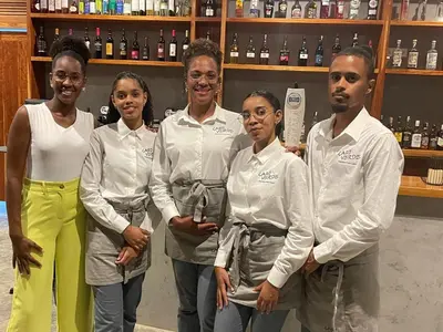 a group of people posing for a picture in a store at Cabo Verde Beach Sport Resort in Porto Novo