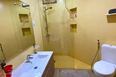 a bathroom with a shower and a sink and a toilet at A Baia do Fortim in Mindelo