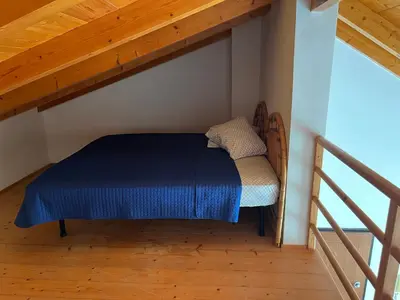 a bed in the attic of a room at Soleil A9 in Santa Maria