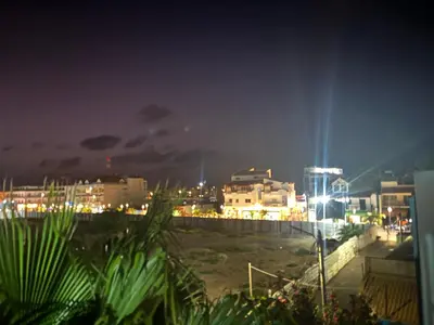 a view of a city at night with lights at Soleil A9 in Santa Maria