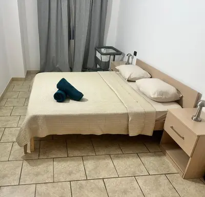 a bed with a blue pillow on top of it at Apart Santa Maria in Santa Maria