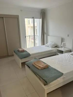 a bedroom with two beds with towels on them at Laginha Views in Mindelo