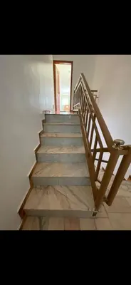 a stairway with a wooden railing and a stair case at La maison paisible in Malveira