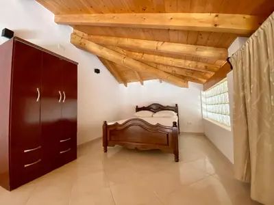 a bedroom with a bed and a wooden ceiling at Estrela do Mar - Rooftop Ocean View in Santa Maria