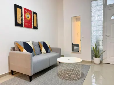 a living room with a couch and a table at 2 bdr cozy apt in Terra Branca, Free Wifi - LCGR in Praia