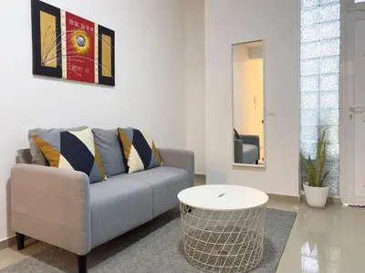 a living room with a couch and a table at 2 bdr cozy apt in Terra Branca, Free Wifi - LCGR in Praia