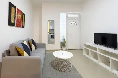 a living room with a couch and a tv at 2 bdr cozy apt in Terra Branca, Free Wifi - LCGR in Praia