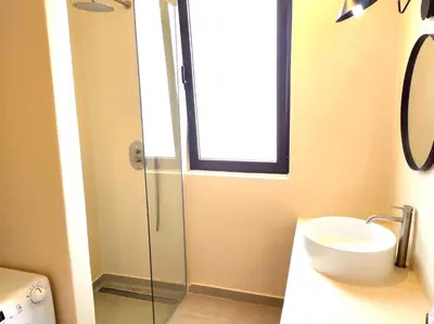 a bathroom with a sink and a glass shower at Stylish Lagoon Paradise Apartment Boa Vista in Sal Rei