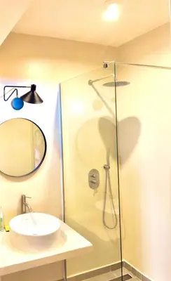 a bathroom with a sink and a glass shower at Stylish Lagoon Paradise Apartment Boa Vista in Sal Rei