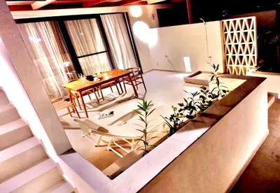 a view of a living room with a table and chairs at Stylish Lagoon Paradise Apartment Boa Vista in Sal Rei