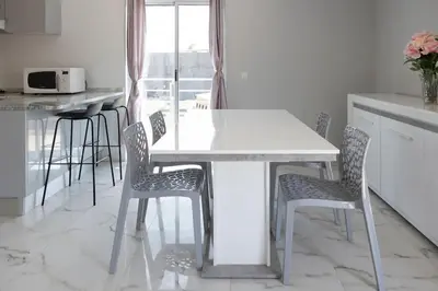 a white table and chairs in a kitchen with a window at 2 bdr cozy apartment in city center, Wifi - LCGR in Assomada