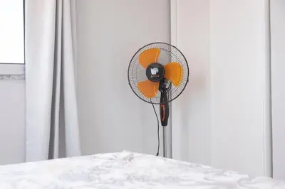 a white and orange fan sitting next to a table at 2 bdr cozy apartment in city center, Wifi - LCGR in Assomada
