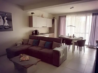 a living room with a couch and a table and a kitchen at Ocean Dream BeachHouse Boa Vista in Sal Rei