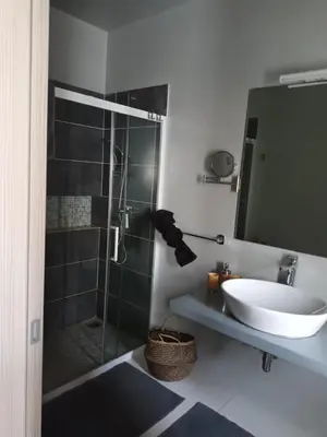 a bathroom with a sink and a glass shower at Ocean Dream BeachHouse Boa Vista in Sal Rei