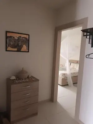 a bedroom with a bed and a dresser and a mirror at Ocean Dream BeachHouse Boa Vista in Sal Rei