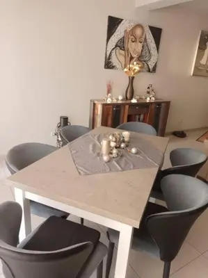 a dining room table with chairs and a table with candles at Ocean Dream BeachHouse Boa Vista in Sal Rei