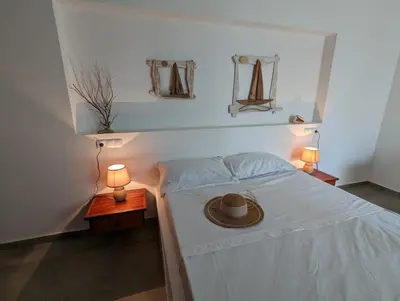 a bedroom with a bed with a hat on it at Vila de Matiz in Vila do Maio