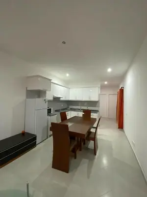a kitchen with a wooden table and a dining room at Apartamento Rua do museu dos Náufragos in Sal Rei