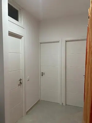 two doors in a room with white walls at Apartamento Rua do museu dos Náufragos in Sal Rei