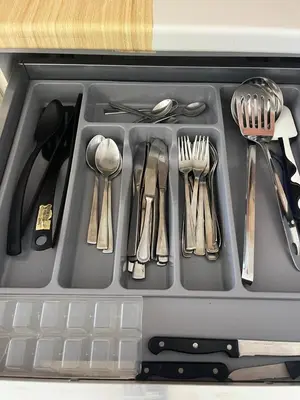a plastic container filled with utensils and utensils at Central Studio Apartment near beach in Santa Maria