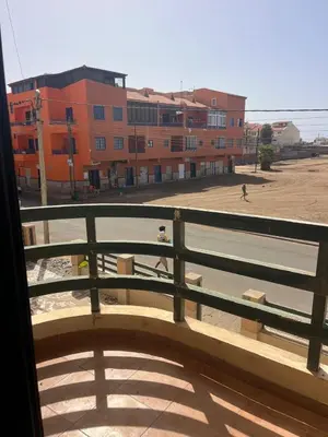 a view of a building from a balcony with a bench at Central Studio Apartment near beach in Santa Maria