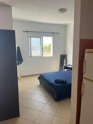 a bedroom with a bed and a window in it at Central Studio Apartment near beach in Santa Maria
