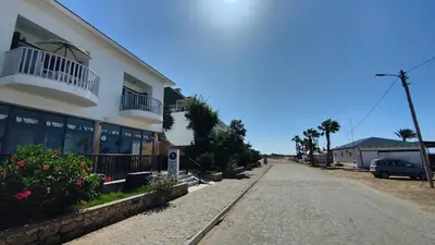 an empty street in front of a building at Albis Harena - Leme Bedje Residence in Santa Maria