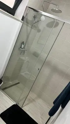a shower with a glass door in a bathroom at CasaZina in Tarrafal