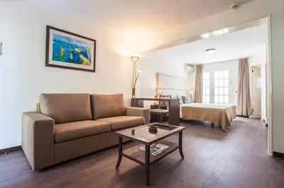 a living room with a couch and a table at Murdeira Village in Beirona