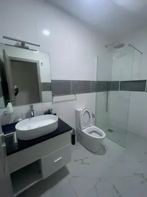 a bathroom with a sink and a toilet and a shower at Appartement standing praia in Praia