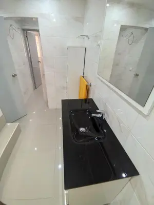 a bathroom with a black sink and a mirror at Casa TIANA in Mindelo