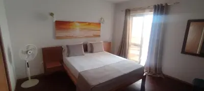 a bedroom with a bed with a fan and a window at Casa TIANA in Mindelo