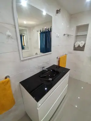 a bathroom with a black sink and a mirror at Casa TIANA in Mindelo