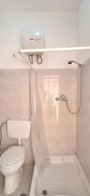 a white bathroom with a toilet and a shower at APARTMENT SALINAS VILA DO MAIO WiFi FREE in Vila do Maio