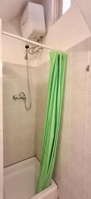 a shower with a green shower curtain in a bathroom at APARTMENT SALINAS VILA DO MAIO WiFi FREE in Vila do Maio