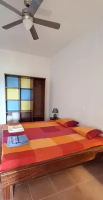 a large bed in a room with a ceiling at APARTMENT SALINAS VILA DO MAIO WiFi FREE in Vila do Maio