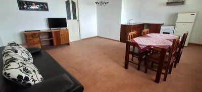 a living room with a table and a kitchen at APARTMENT SALINAS VILA DO MAIO WiFi FREE in Vila do Maio