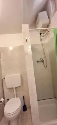 a white bathroom with a toilet and a shower at APARTMENT SALINAS VILA DO MAIO WiFi FREE in Vila do Maio