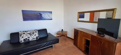 a living room with a couch and a flat screen tv at APARTMENT SALINAS VILA DO MAIO WiFi FREE in Vila do Maio