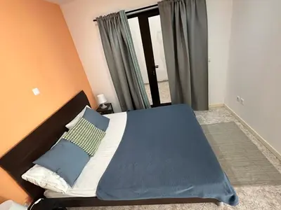 a bedroom with a bed with blue sheets and a window at Coração de Santa Maria in Santa Maria